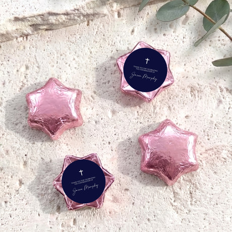 Pink foil star chocolates with dark blue round label featuring cross and message