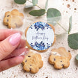 Round cookie with blue floral “Happy Mother’s Day” icing, sealed in clear wrapper.