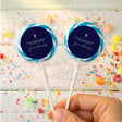 Personalized lollipops with navy round labels, white cross, in clear wrappers.