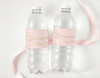 Personalised water bottle labels with pale pink cross design on two clear bottles