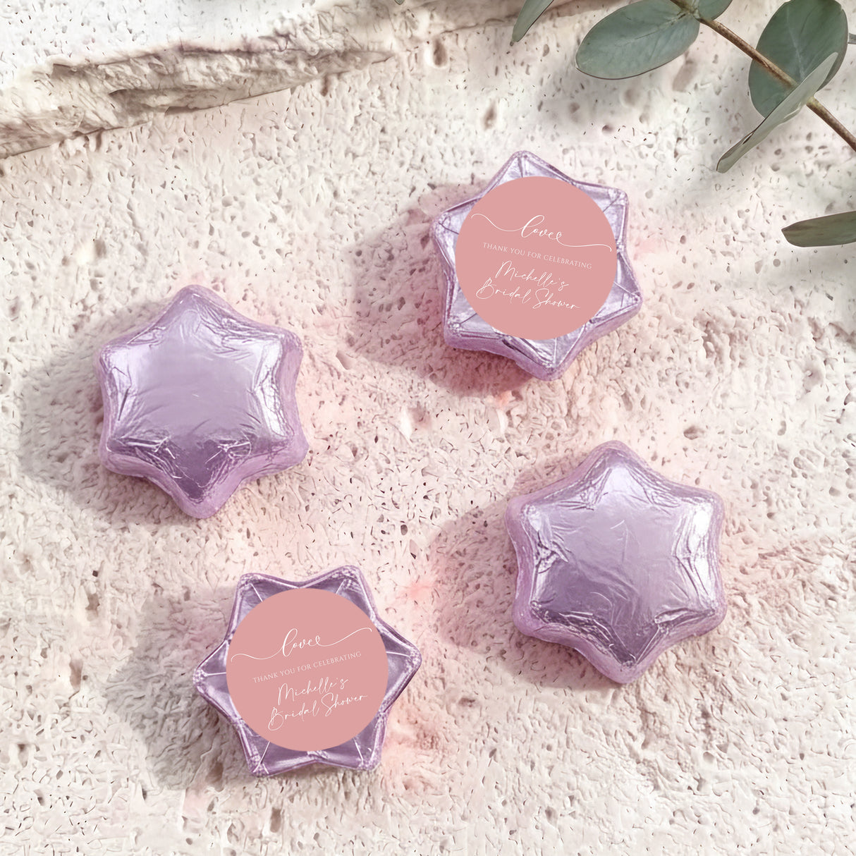 Set of purple and lavender foil-covered chocolate stars with pink heart labels