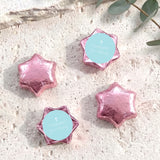 Pink foil star covered chocolates with a white cross on a round center label
