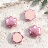 Star-shaped foil chocolates in pink, with pale center and cross design