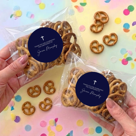 Christening pretzel bag set with clear wrapped pretzels and navy round cross label