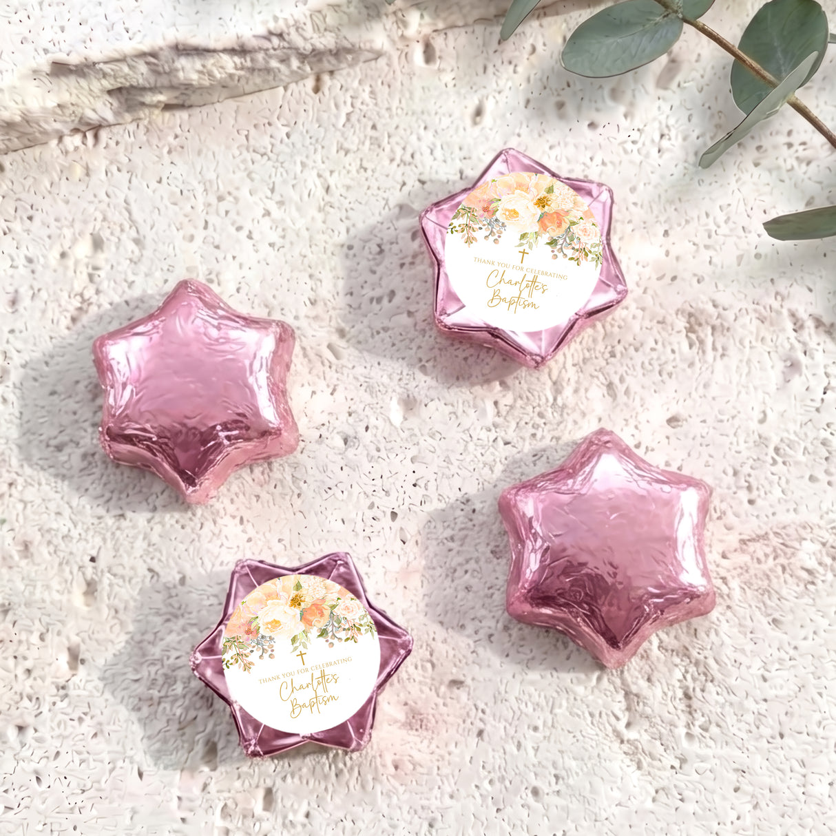 Foil-covered chocolate stars in pink and purple with a floral personalisation label