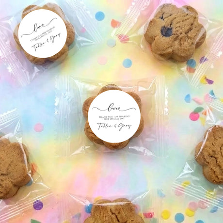 Chocolate chip cookies with round personalized labels in a clear plastic bag