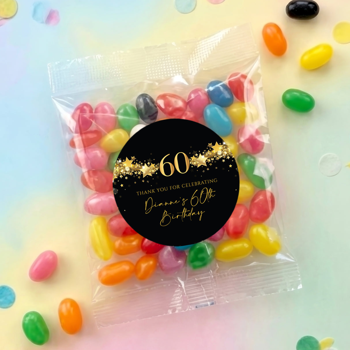 Clear jelly bean bag with black round label and gold '60' party text