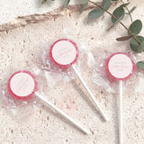 Mini lollipops with red lollipop tops, wrapped in clear plastic on white sticks.
