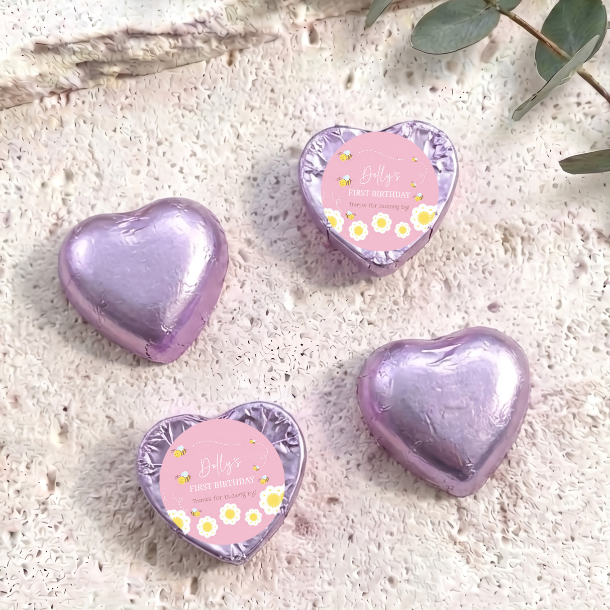 Foil-covered purple chocolate heart chocolates with birthday labels, four foil hearts shown