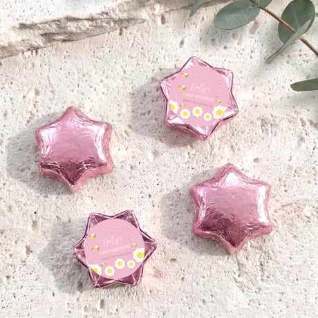 Pink foil-covered chocolate star with “Dolly’s First Birthday” bee label on front