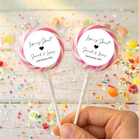Personalised wedding lollipop, pink ribbon tie, clear wrap, round label sticker on white stick.