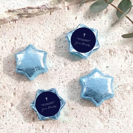 Light blue foil star chocolates with dark blue round label featuring cross and message