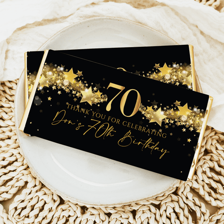 70th male birthday chocolate bar wrapper, black with gold stars and “Happy 70th”