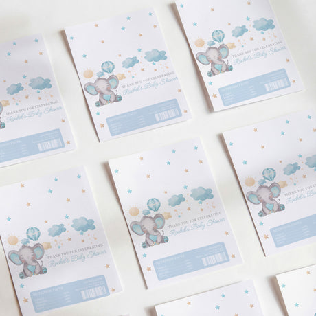 Blue elephant baby shower chocolate wrappers, pastel clouds and stars, with barcode label