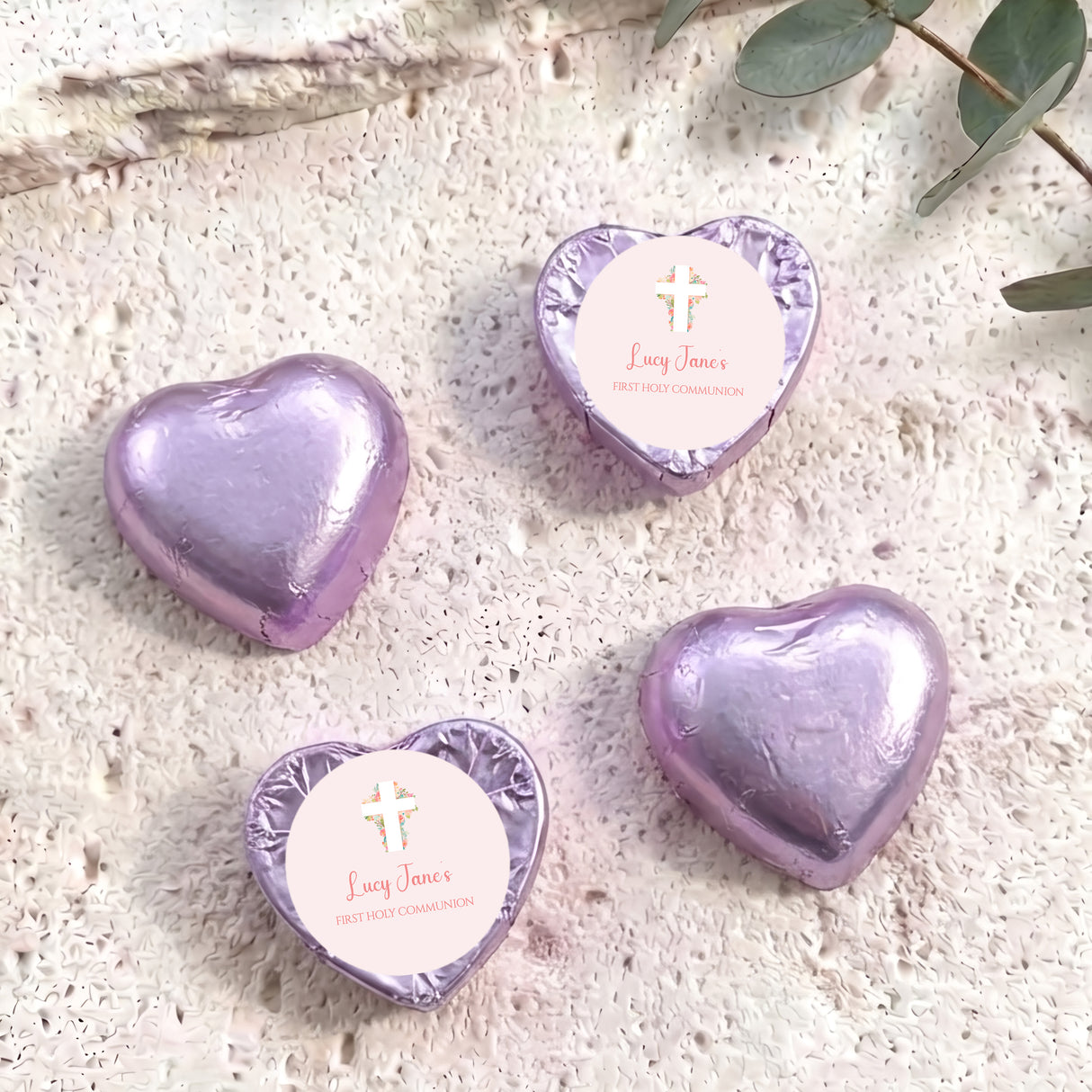 Purple foil heart chocolates with white label, cross and “Lucy Janes” First Holy Communion