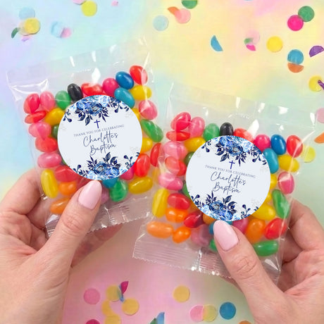 Two personalised jelly bean bags with navy floral round labels and clear pouches of colorful beans