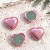 Pink heart-shaped foil-covered chocolate hearts with round thank-you label