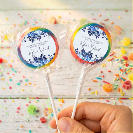 Personalised lollipop pair with navy floral labels, 'Kyle & Richard', rainbow wrap