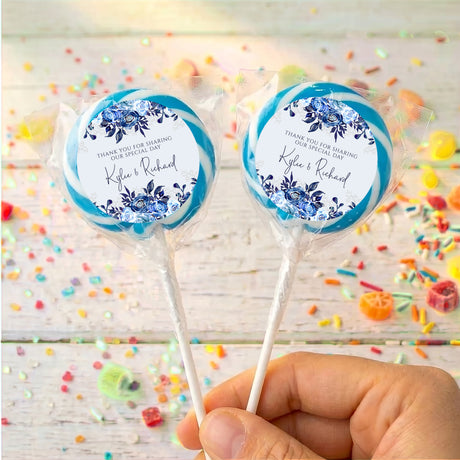 Personalised lollipop pair with navy floral labels, 'Kyle & Richard', blue wrap