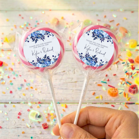 Personalised lollipop pair with navy floral labels, 'Kyle & Richard', pink wrap