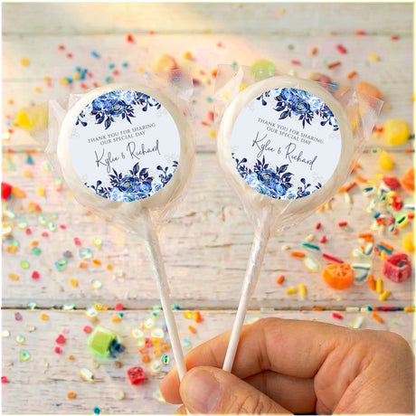 Personalised lollipop pair with navy floral labels, 'Kyle & Richard', clear wrap