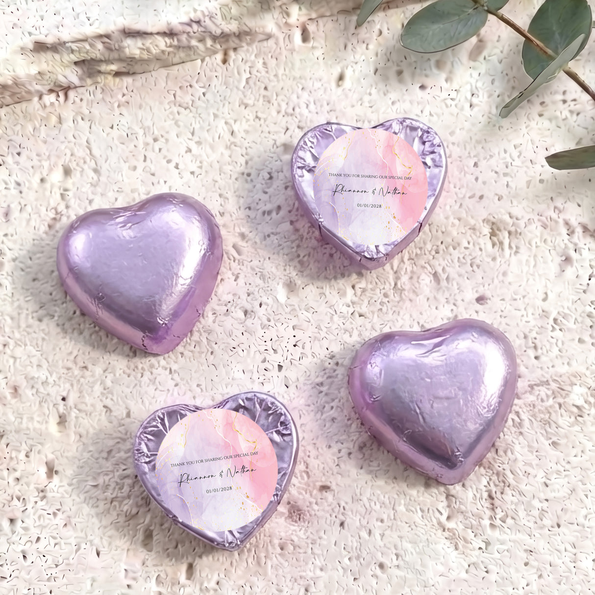 Foil-covered chocolate heart in lavender purple with round pink name label