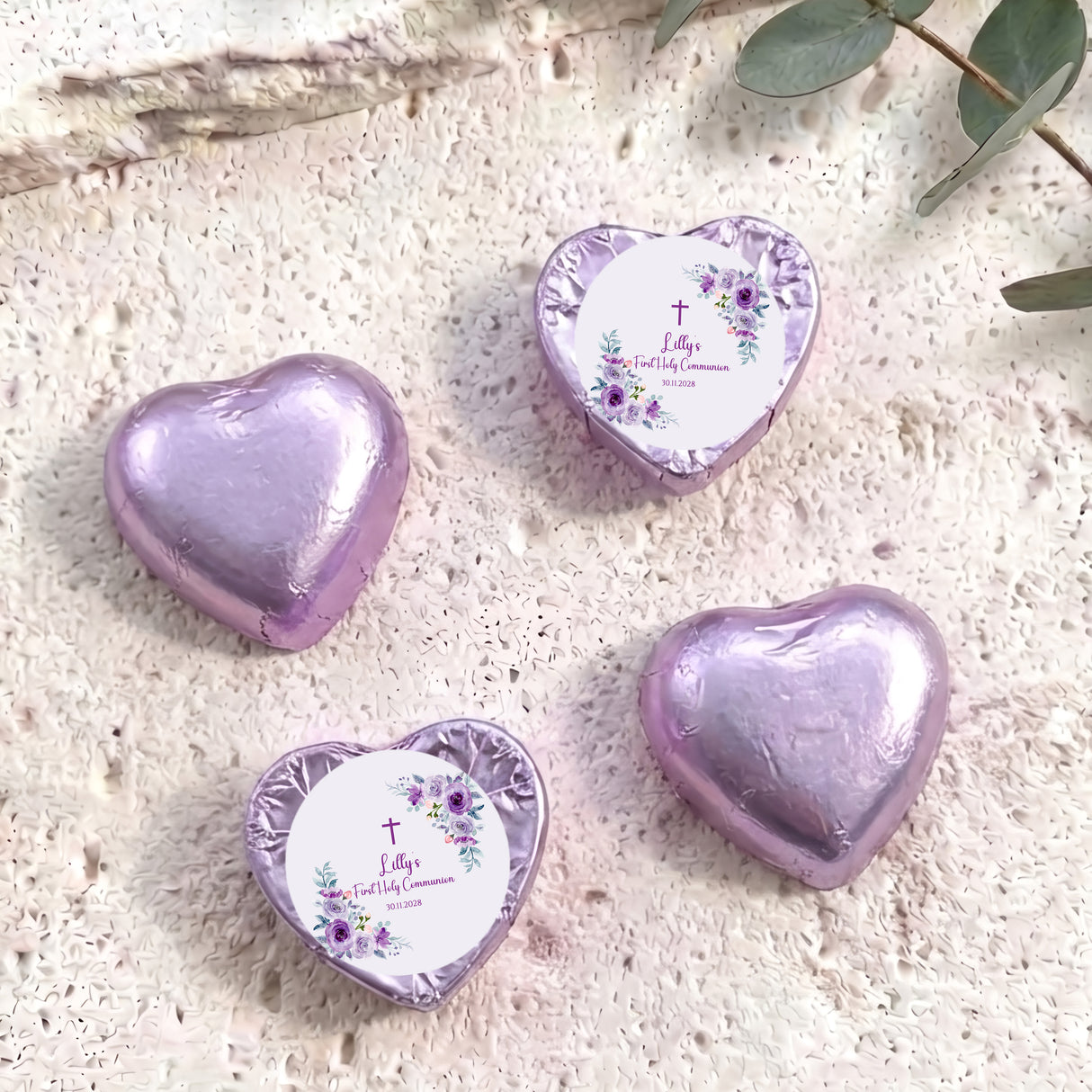 Foil-covered chocolate hearts with lavender finishes, floral cross message medallions