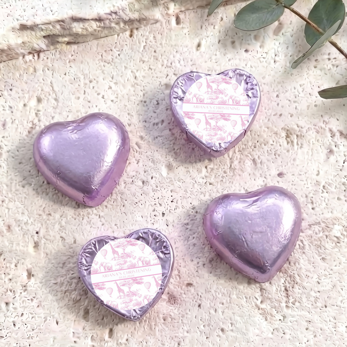 Assorted pink foil chocolate hearts, two with foil-backed personalised christening labels
