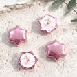 Pink star-shaped foil balloons with 'Charlotte's Baby Shower' teddy design