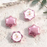 Pink star-shaped foil balloons with 'Charlotte's Baby Shower' teddy design