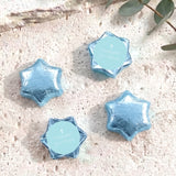 Pastel blue foil star covered chocolates with a white cross on a round center label