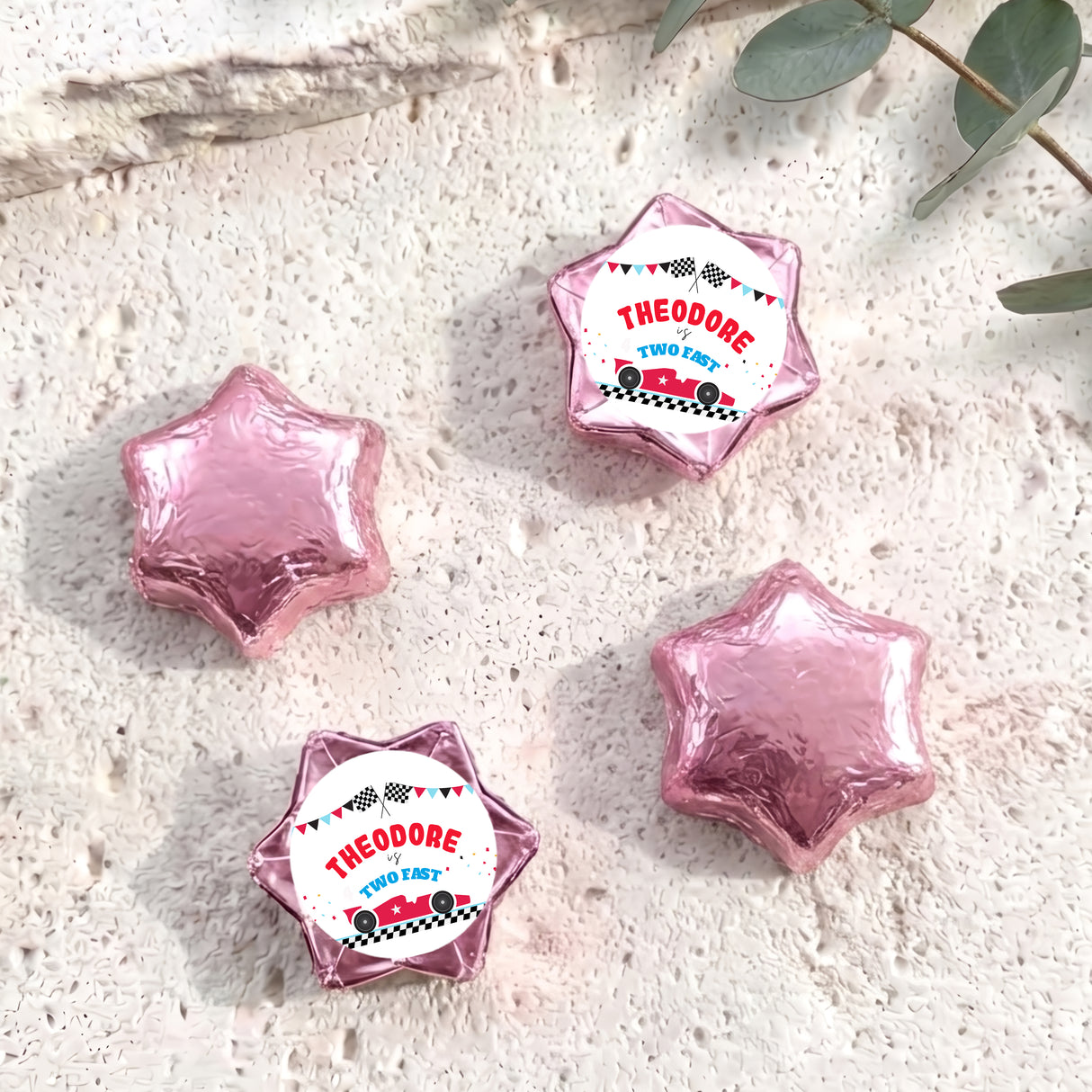Pink foil-covered star chocolates with personalised label wrappers, four pieces shown