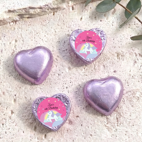 Purple-lavender foil chocolate hearts with unicorn “Zara’s 6th Birthday” label.