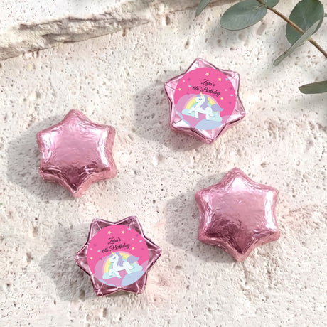 Pink star-shaped foil chocolate with “Zara’s 6th Birthday” unicorn rainbow label
