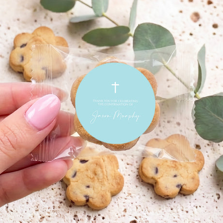 Cross-themed confirmation cookies with blue thank-you label, one cookie close-up