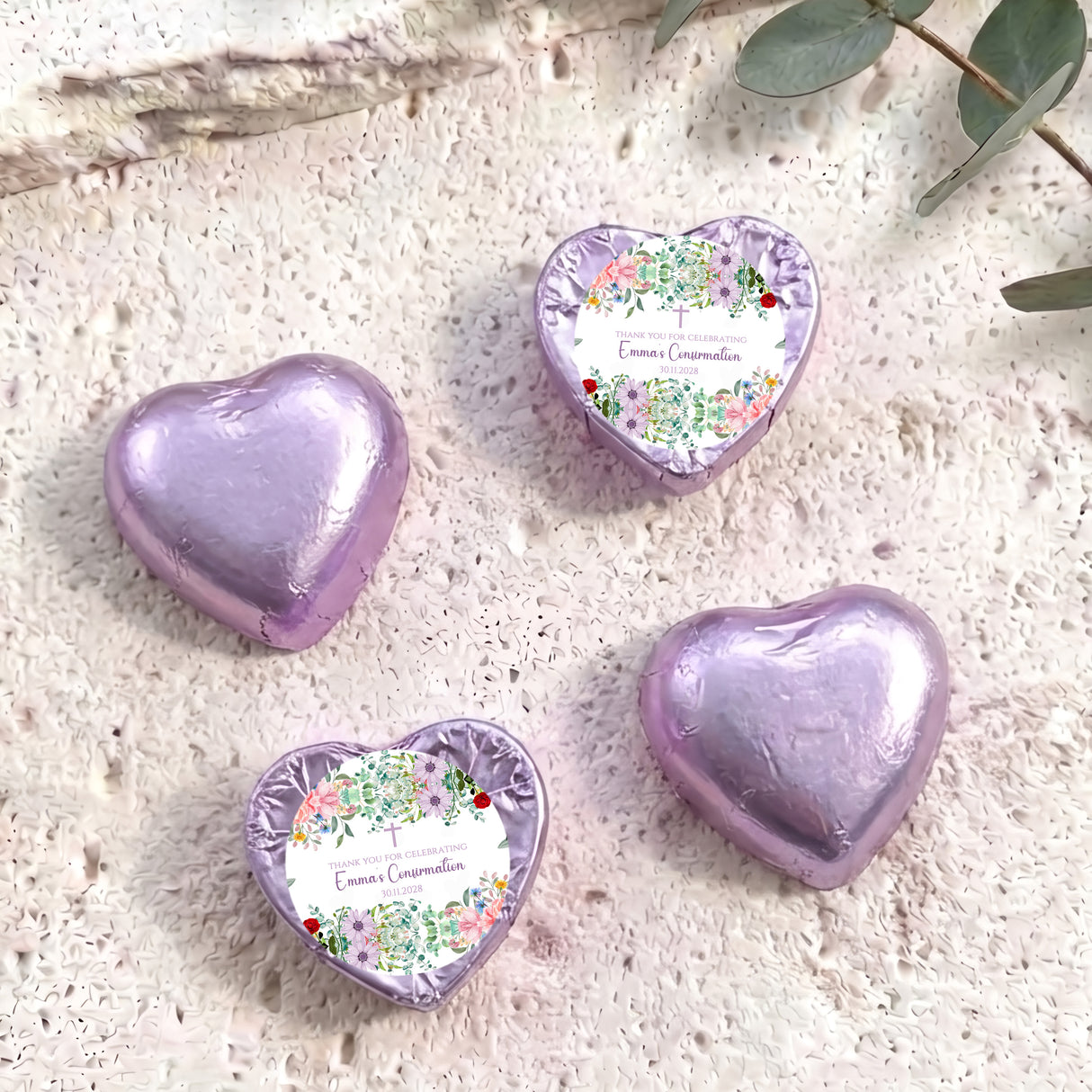 Foil-covered purple heart chocolates with floral personalised labels