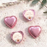 Pink heart-shaped foil chocolate with “Happy Mother’s Day” floral message on white center