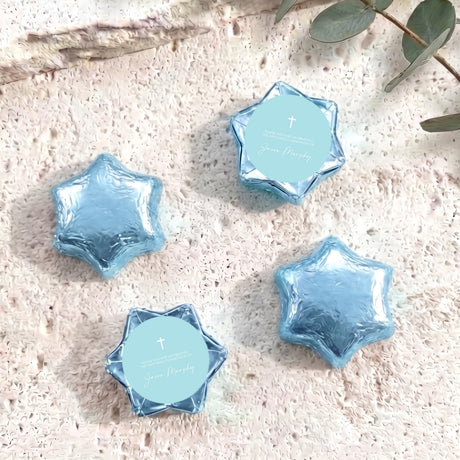 Pastel blue foil-covered chocolate stars with cross medallion labels