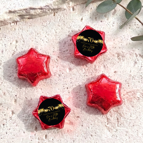 Red foil chocolate stars with 70th birthday personalised label, star-shaped sweets