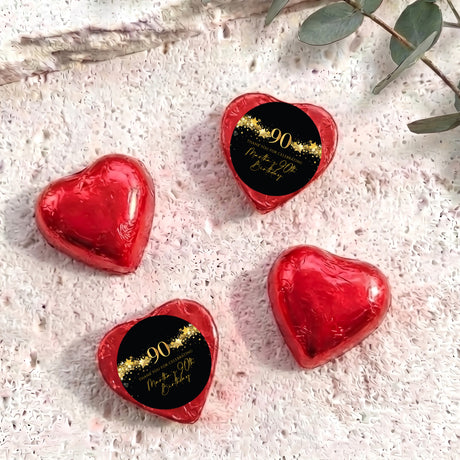Red foil heart chocolates with black 90 birthday label and gold star text