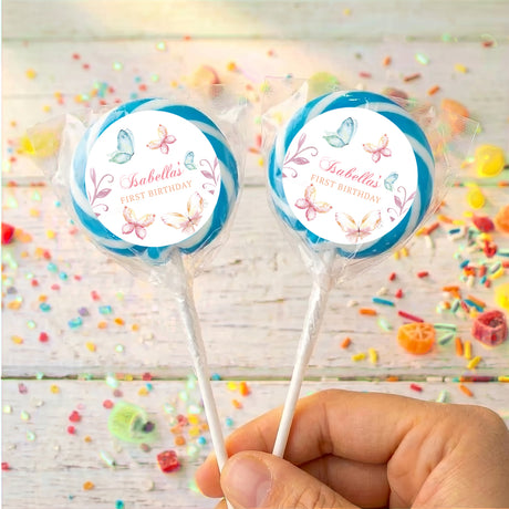Personalised lollipops: two pastel butterfly round labels on sticks with blue edging.