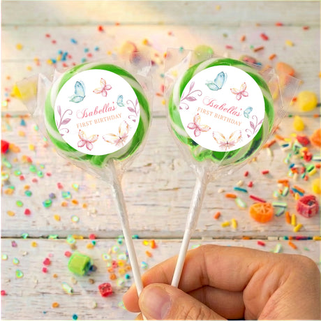 Personalised lollipops: two pastel butterfly round labels on sticks with green edging.