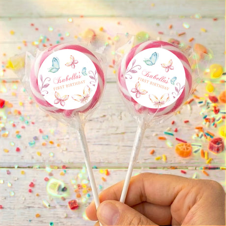 Personalised lollipops: two pastel butterfly round labels on sticks with pink edging.