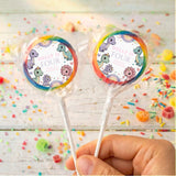 Rainbow-rim dinosaur birthday lollipops with round “Dolly is Four” wrapper labels