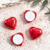 Red foil-covered chocolate hearts with heart-shaped foil wrap and white label