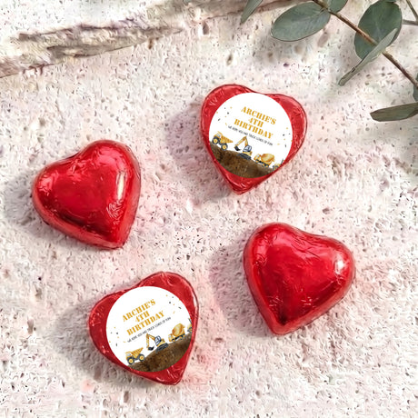 Foil-covered chocolate hearts in red foil with birthday label featuring a construction truck