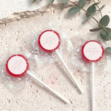 Mini lollipops with red lollipop tops, wrapped in clear plastic on white sticks.