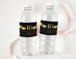 Clear water bottles with black 40th birthday label and gold star accents