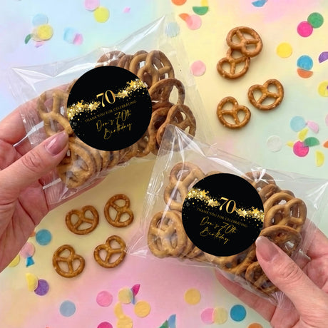 70th birthday pretzel bag with dark round label, gold stars, “70” and mini pretzels