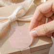 Pastel peach round First Communion labels with white cross and printed thank-you text